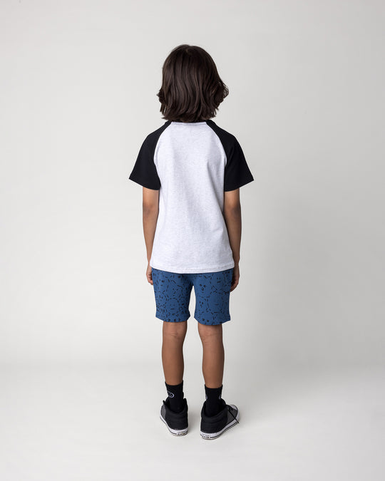 Kid wearing the Different Faces Short in midnight with the Later Gator Tee in white marle and black, back view