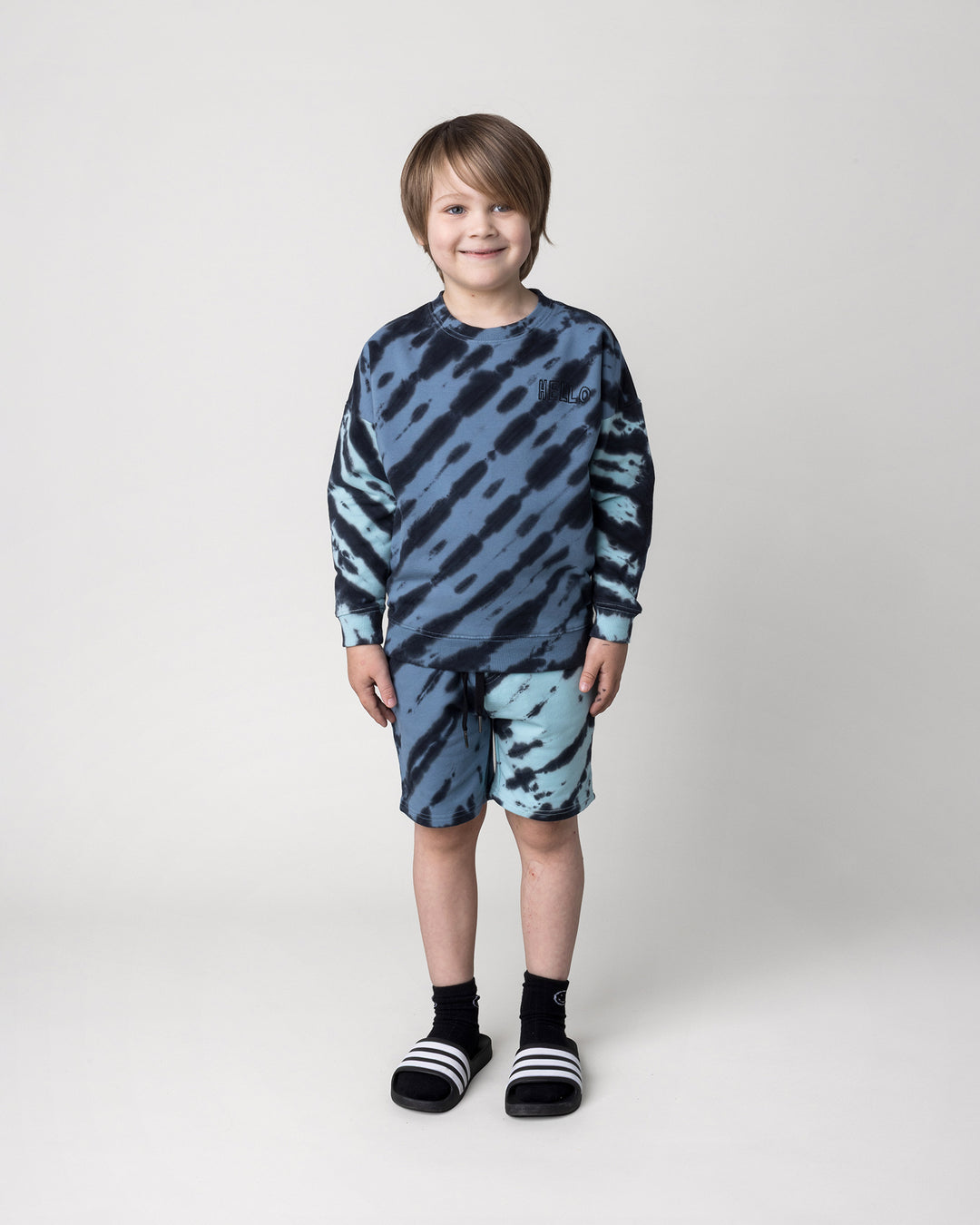 Kid wearing the Duo Tie Dye Short in blue and aqua with the Duo Tie Dye Crew in blue and aqua, front view
