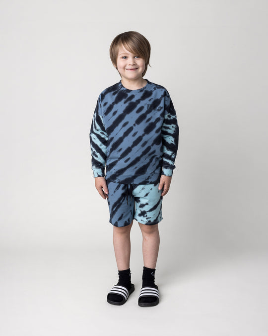 Kid wearing the Duo Tie Dye Short in blue and aqua with the Duo Tie Dye Crew in blue and aqua, front view