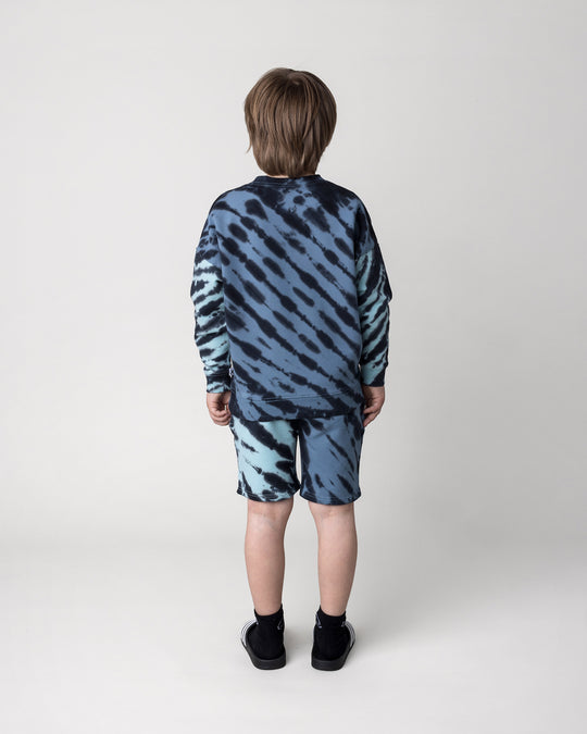 Kid wearing the Duo Tie Dye Short in blue and aqua with the Duo Tie Dye Crew in blue and aqua, back view