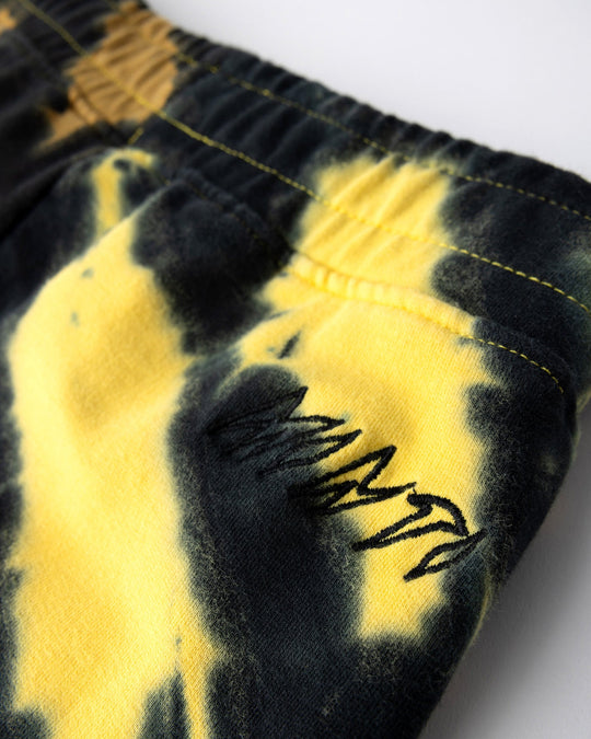 Close up detail of the Duo Tie Dye Short in lemon and rust