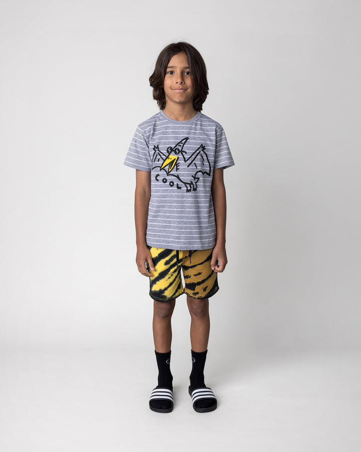 Kid wearing the Duo Tie Dye Short in lemon and rust with the Cool Pterodactyl Tee in grey stripe, front view