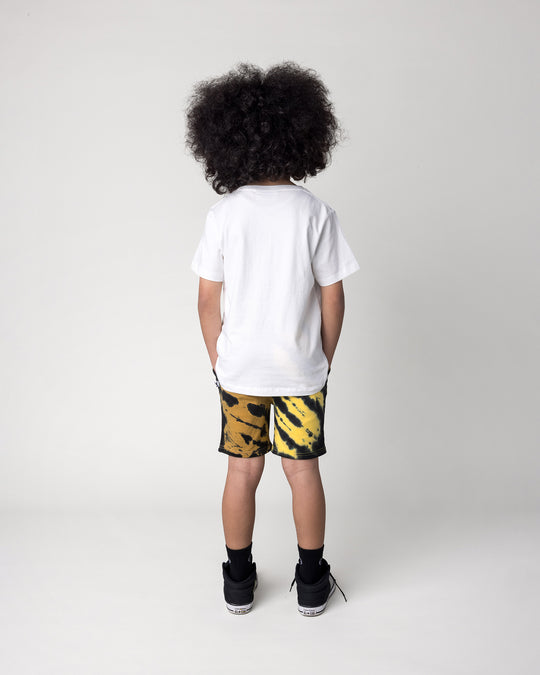 Kid wearing the Duo Tie Dye Short in lemon and rust with the Super Cool Tee in off white, back view