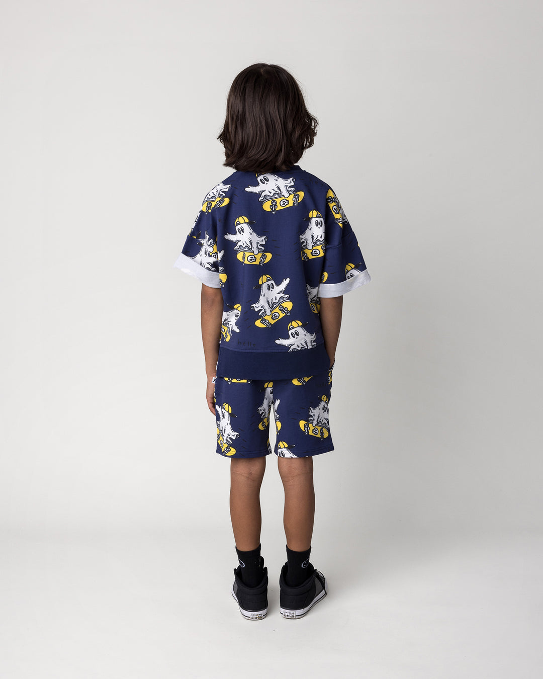 Kid wearing the Skate Ghost Short in dark blue with the Skate Ghost Short Sleeve Crew in dark blue, back view