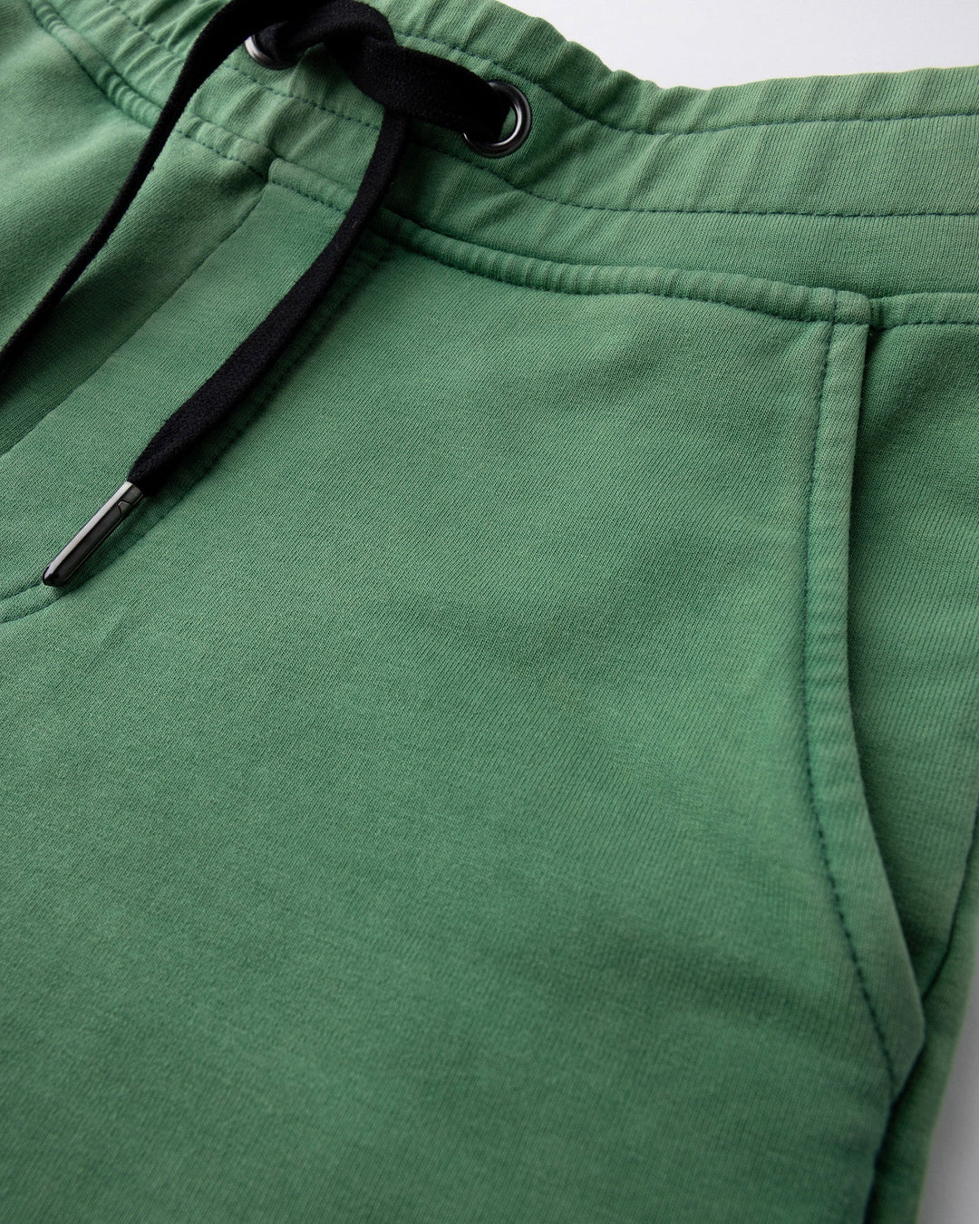 Close up detail of the Blasted Icon Short in turf wash