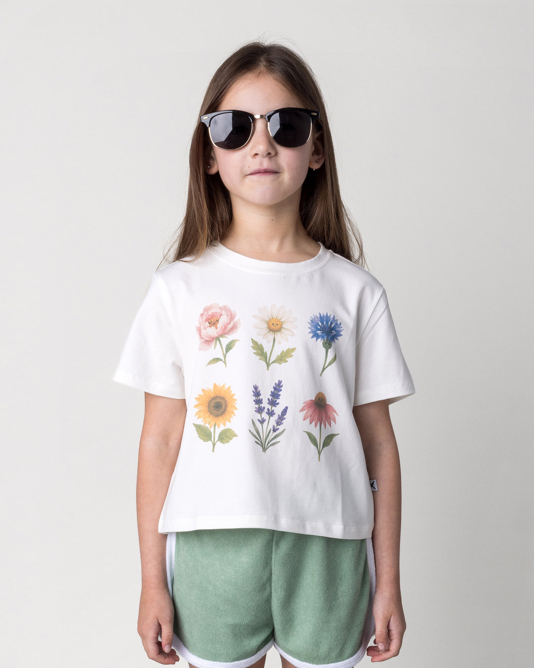 Close up of the Flower Friends Cropped Tee in white on a kid, front view