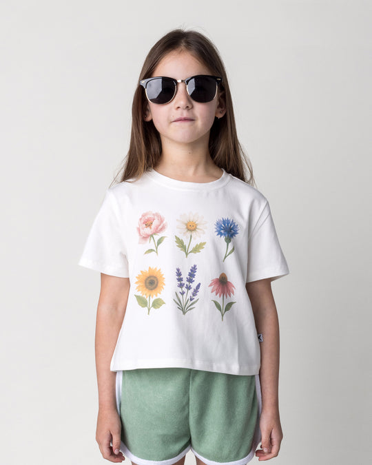 Close up of the Flower Friends Cropped Tee in white on a kid, front view