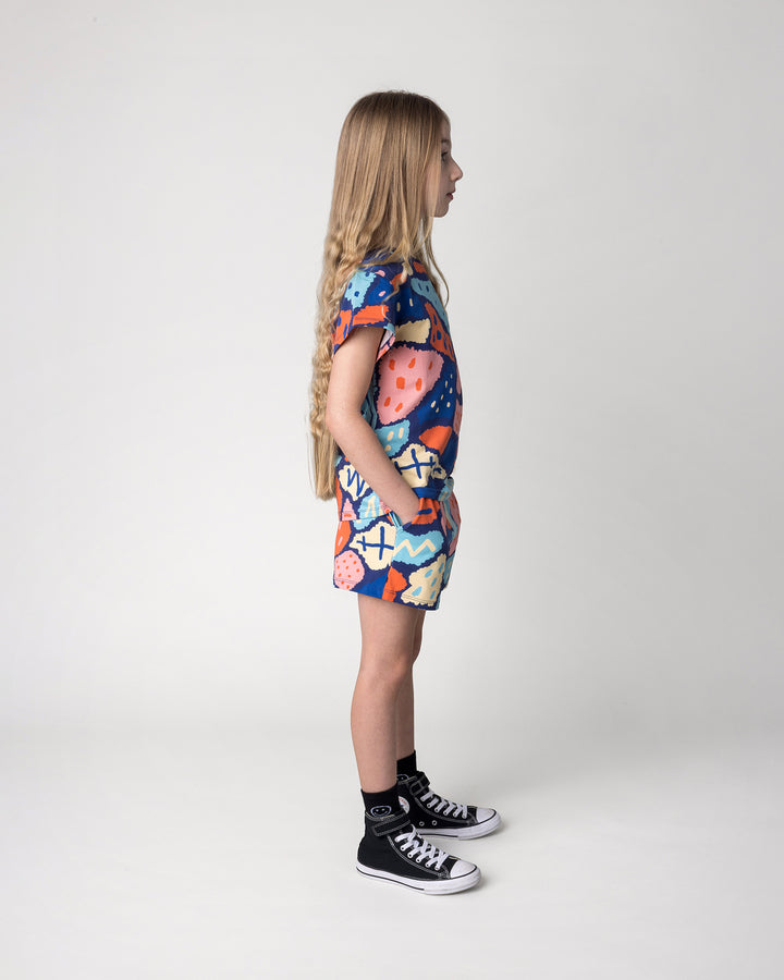Kid wearing the Cool Shapes Short in dark blue with the Cool Shapes Tee in dark blue, side view