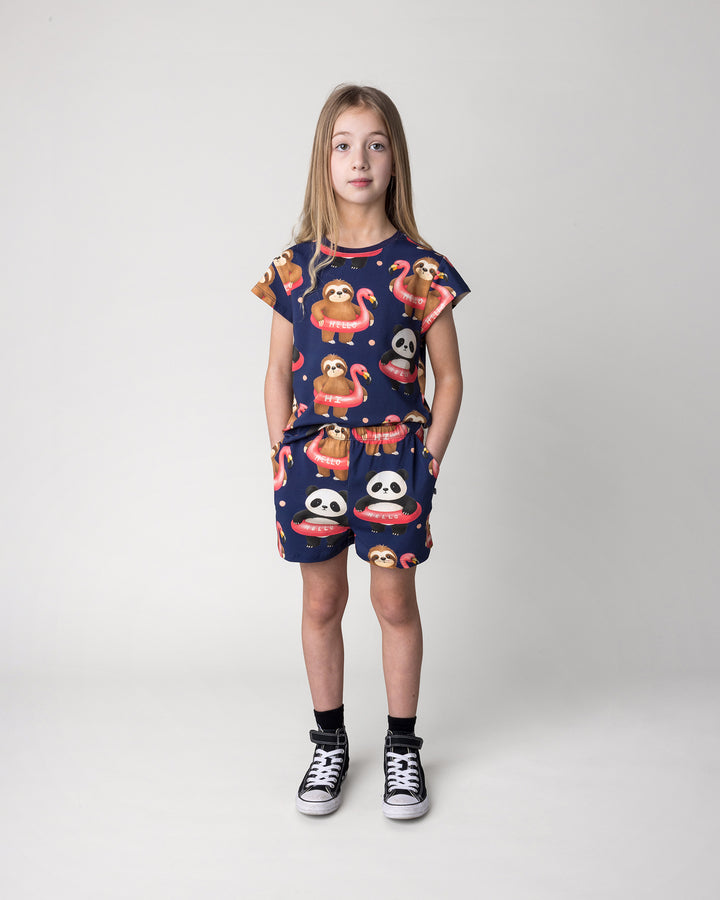 Kid wearing the Swimming Buddies Short in midnight with the Swimming Buddies Tee in midnight, front view