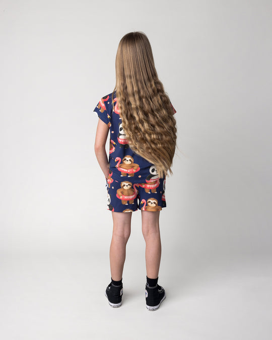 Kid wearing the Swimming Buddies Short in midnight with the Swimming Buddies Tee in midnight, back view
