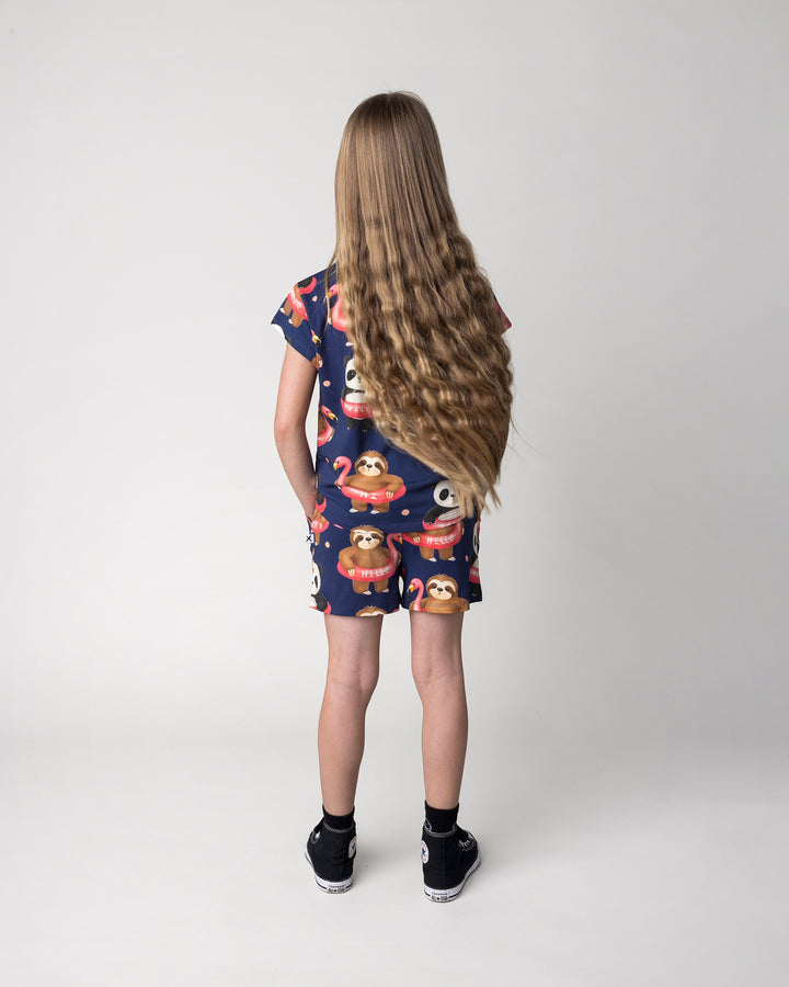 Kid wearing the Swimming Buddies Short in midnight with the Swimming Buddies Tee in midnight, back view