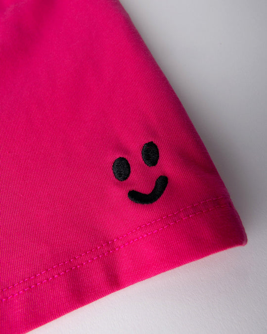 Close up detail of the Two Tone Short in hot pink and aqua