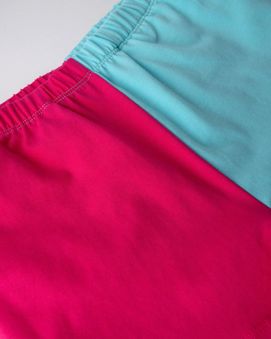 Close up detail of the Two Tone Short in hot pink and aqua