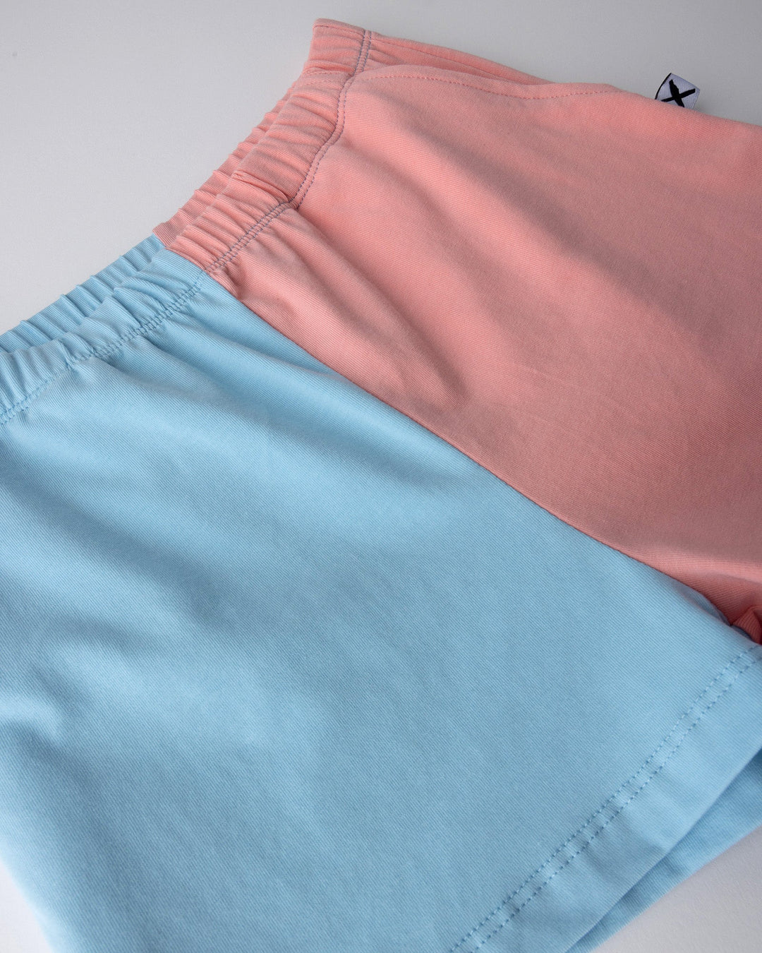 Close up detail of the Two Tone Short in light blue and pink