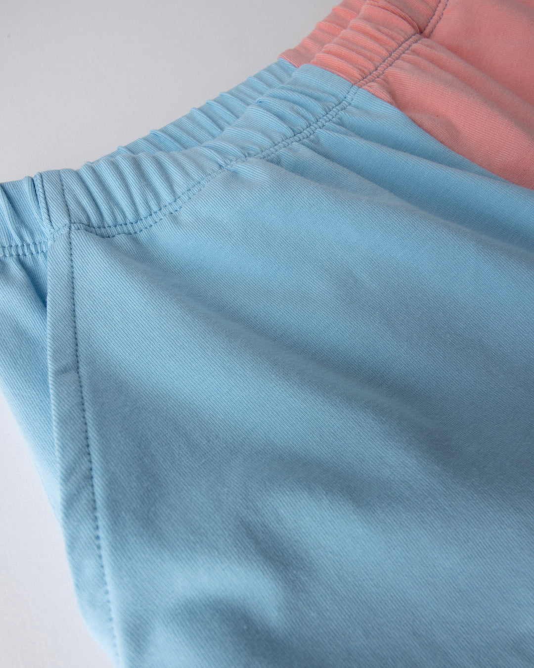 Close up detail of the Two Tone Short in light blue and pink