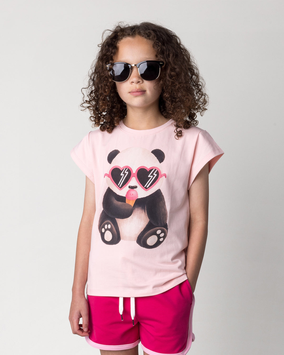 Close up of the Icecream Panda Tee in light pink on a kid, front view