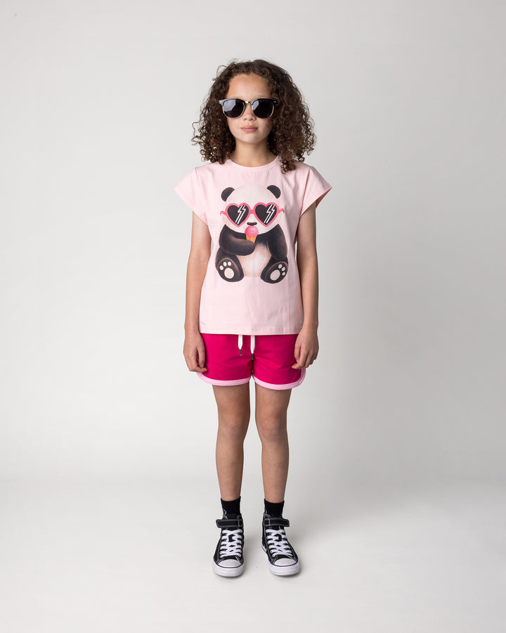 Kid wearing the Icecream Panda Tee in light pink with the Sprint Short in crimson and pink, front view