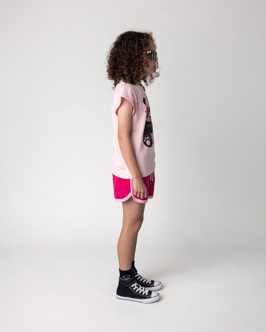 Kid wearing the Icecream Panda Tee in light pink with the Sprint Short in crimson and pink, side view