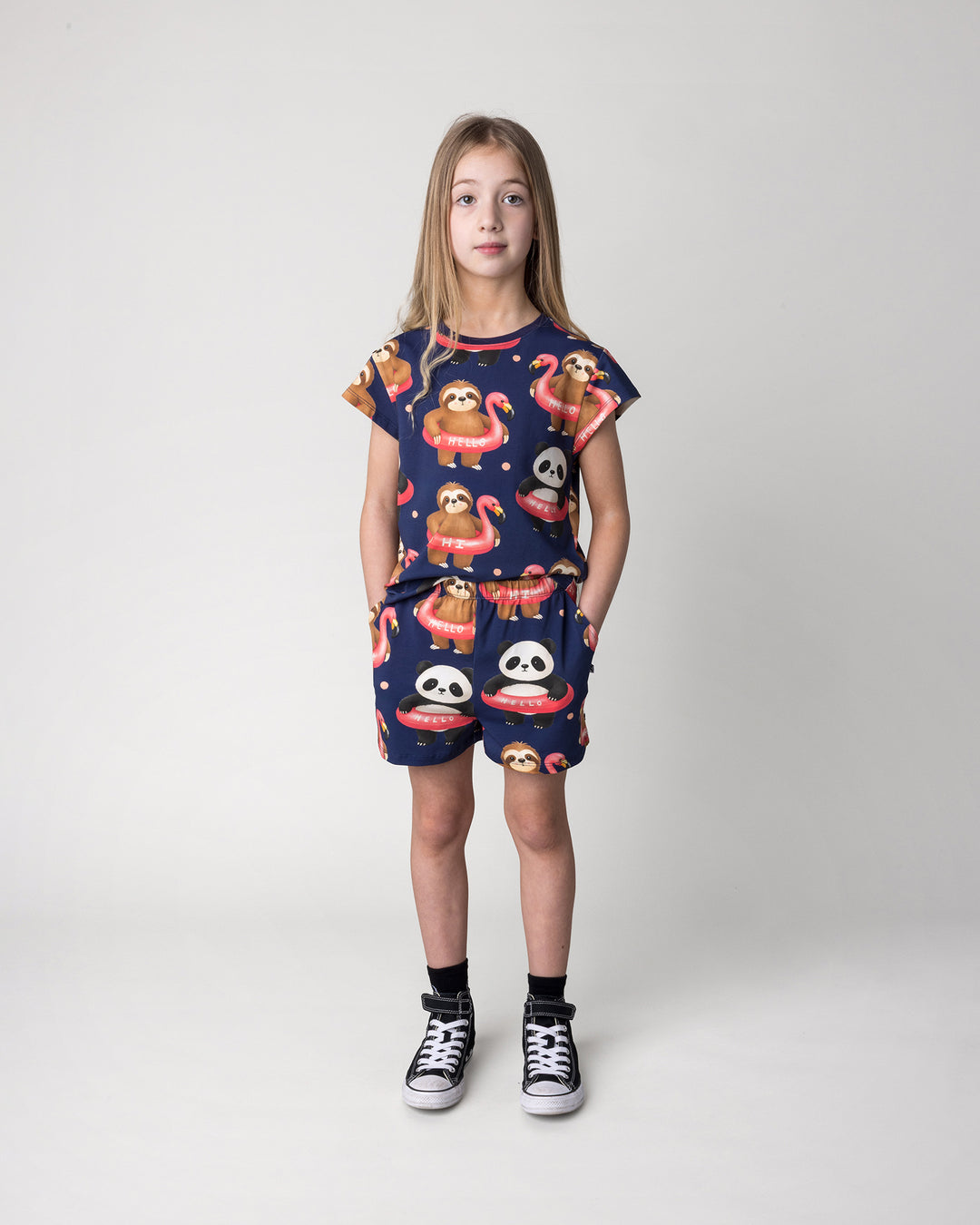 Kid wearing the Swimming Buddies Tee in midnight with the Swimming Buddies Short in midnight, front view