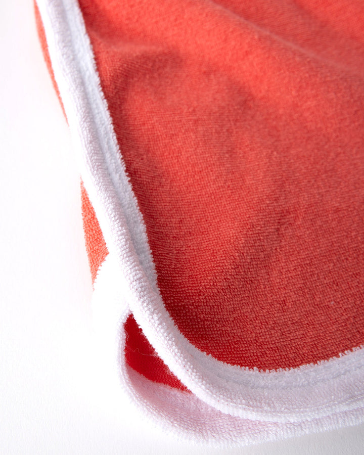 Close up detail of the Track Star Short in tangerine