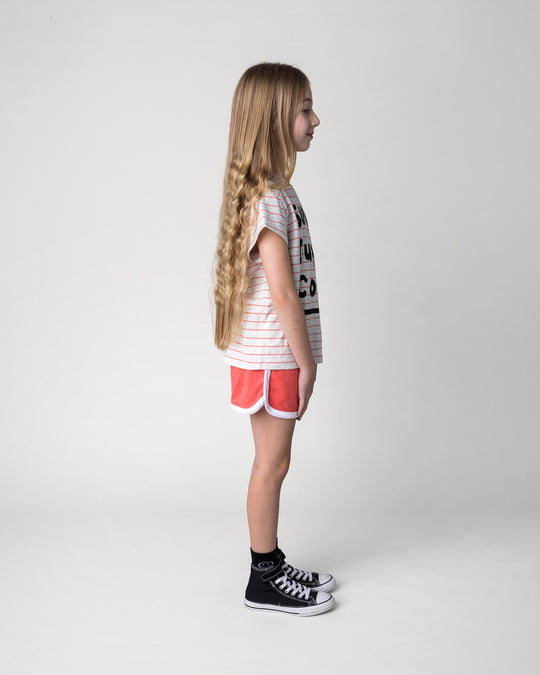 Kid wearing the Track Star Short in tangerine with the Super Duper Cool Tee in marle and coral stripe, side view