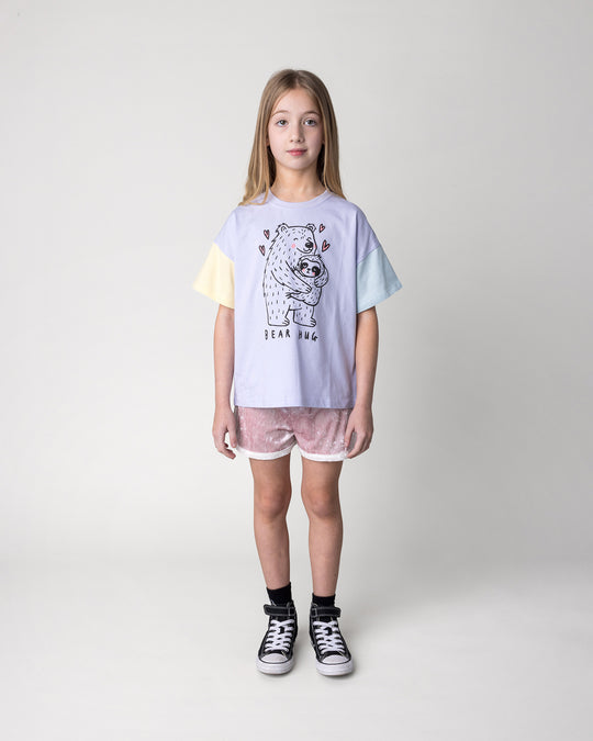 Kid wearing the Velvet Runner Short in blush and cream with the Bear Hug Tee in lilac, lemon and blue, front view