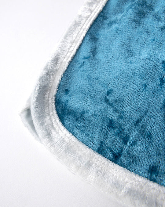 Close up detail of the Velvet Runner Short in light blue and cream