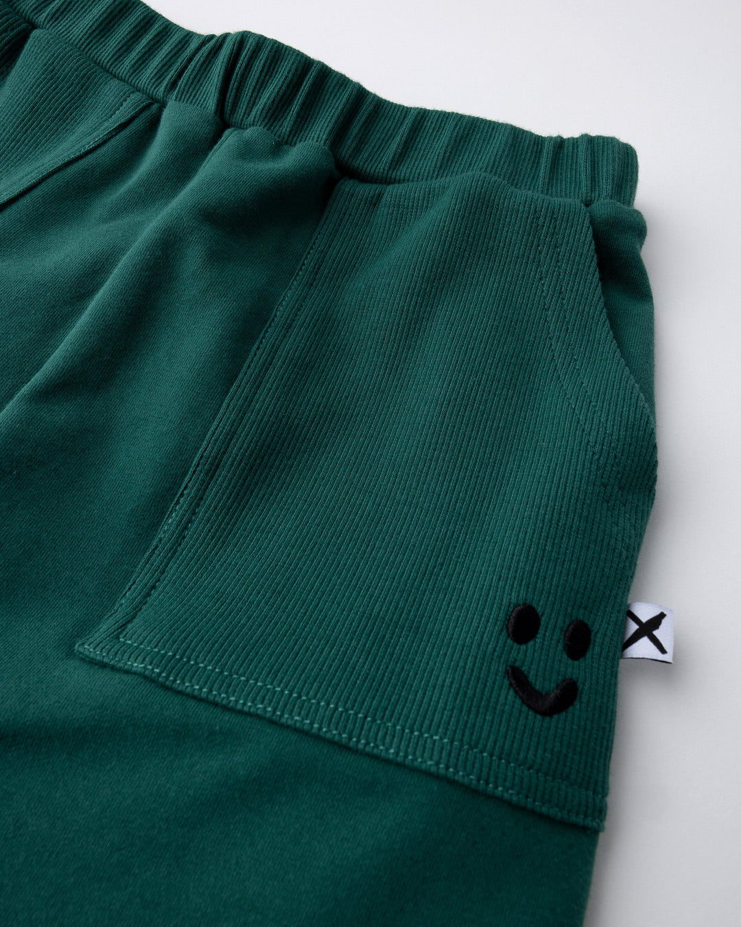 Close up detail of the Rib Pocket Short in kelly green