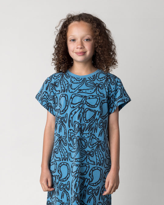 Close up of the Big Bows Dress in blue wash on a kid, front view