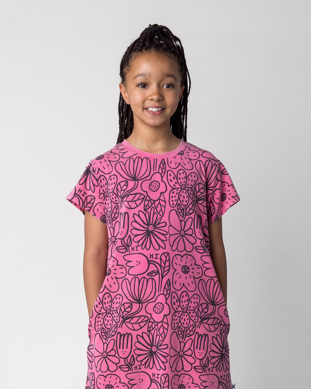 Close up of the Big Flowers Dress in pink wash on a kid, front view