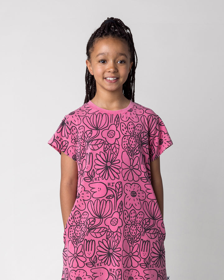 Close up of the Big Flowers Dress in pink wash on a kid, front view