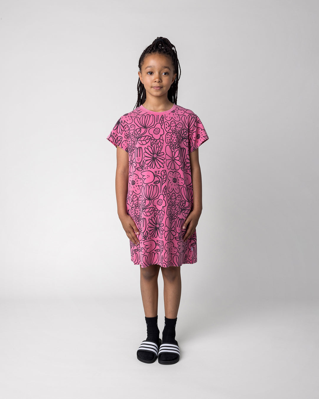 Kid wearing the Big Flowers Dress in pink wash, front view