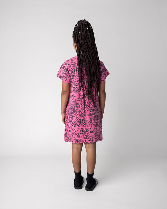 Kid wearing the Big Flowers Dress in pink wash, back view