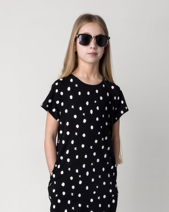 Close up of the Spotty Dress in black on a kid, front view