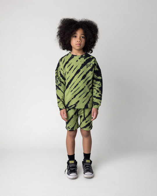 Kid wearing the Strike Crew in lime with the Strike Short in lime, front view