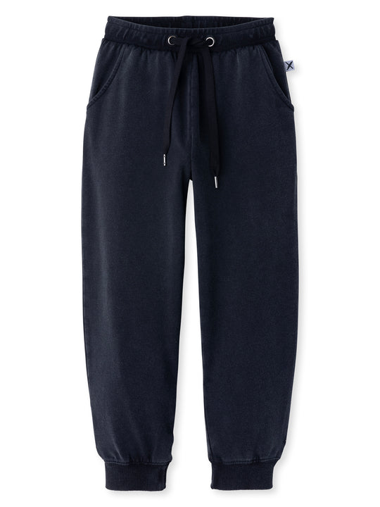 Minti kids clothing. Relaxed universal fit trackies with cosy side pockets, elasticated waistband, shoelace cord and 2x2 Rib cuffs. Small Minti embroidery on the back. 260 Gram // 95% Cotton // 5% Elastane.