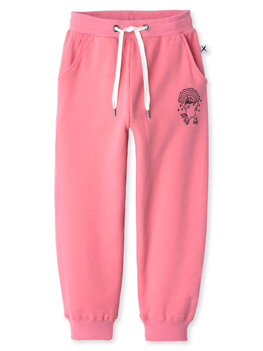 Minti kids clothing. Relaxed fit trackies with cosy side pockets, elasticated waistband, shoelace cord and 2x2 Rib cuffs. Small Magical Rainbow Unicorn print on the front. 330 Gram // Brushed Inside // 95% Cotton // 5% Elastane.