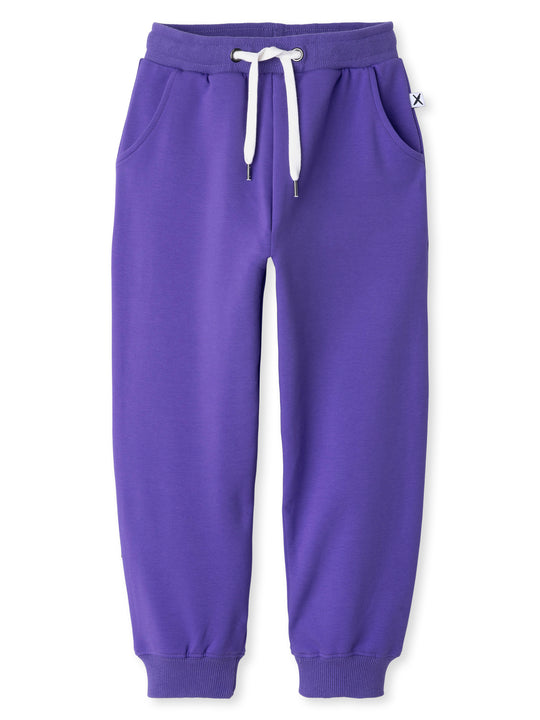 Minti kids clothing. Relaxed fit trackies with cosy side pockets, elasticated waistband, shoelace cord and 2x2 Rib cuffs. 320 Gram // 95% Cotton // 5% Elastane.