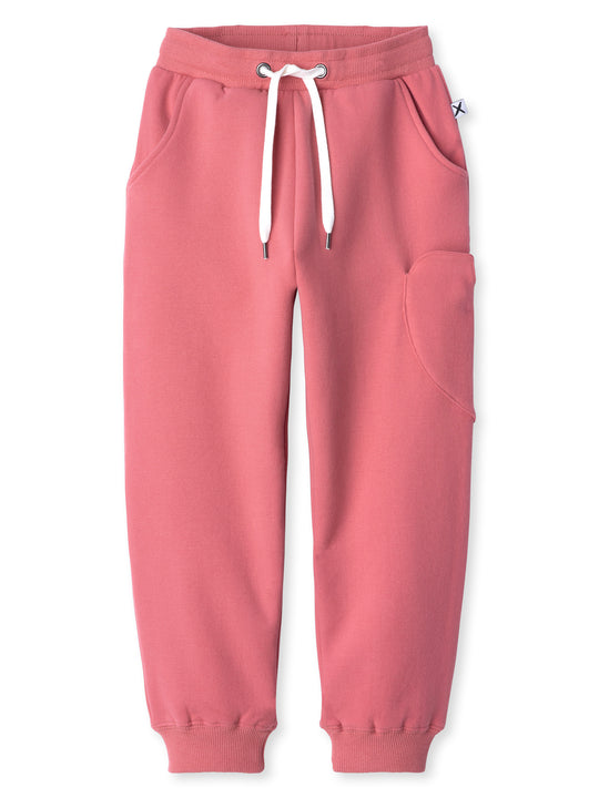 Minti kids clothing. Relaxed fit trackies with a super cool heart shaped side pocket. Front pockets, elasticated waistband, shoelace cord and 2x2 Rib cuffs. 330 Gram // Brushed Inside // 95% Cotton // 5% Elastane.
