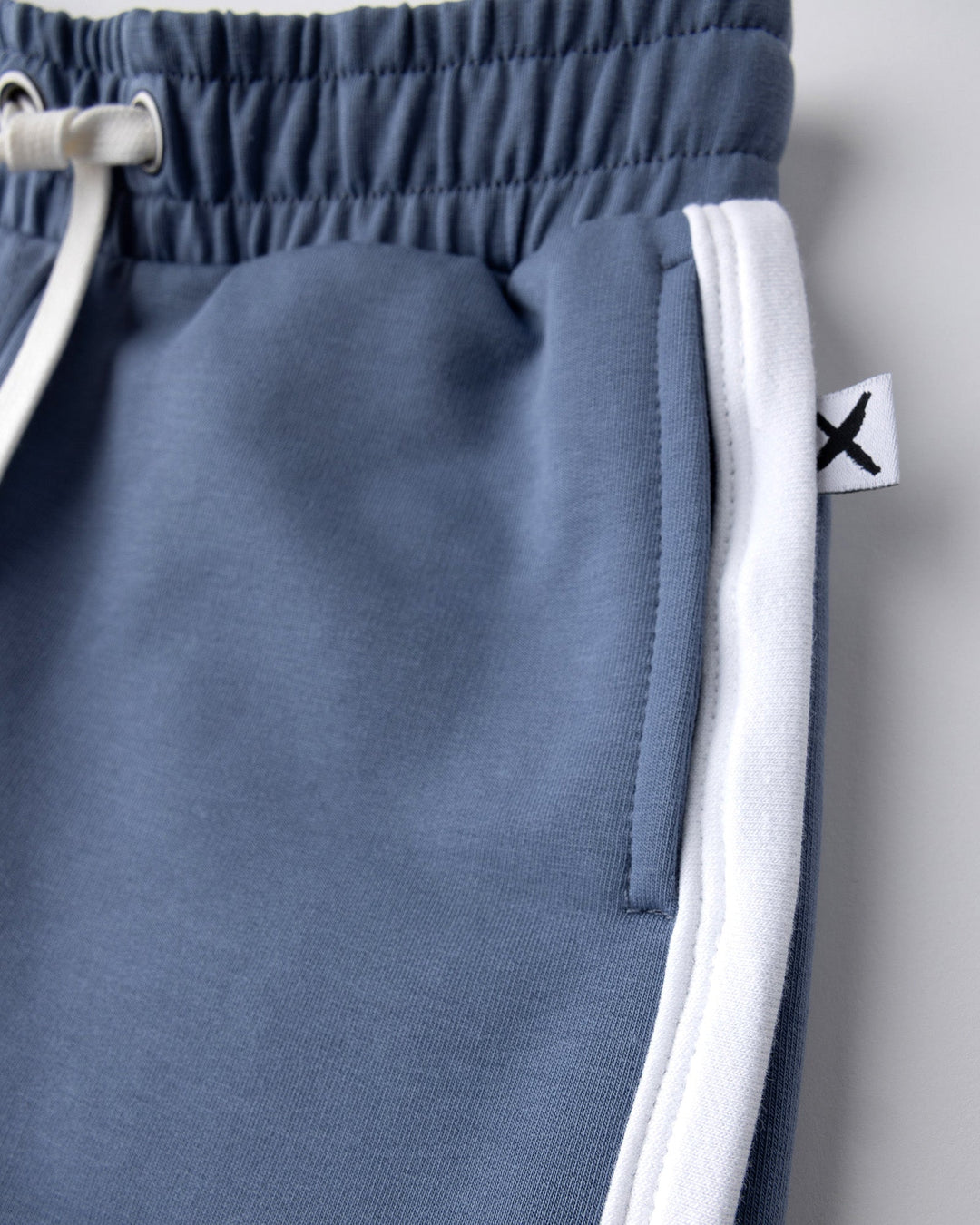 Close up detail of the Sprint Short in cornflower and white
