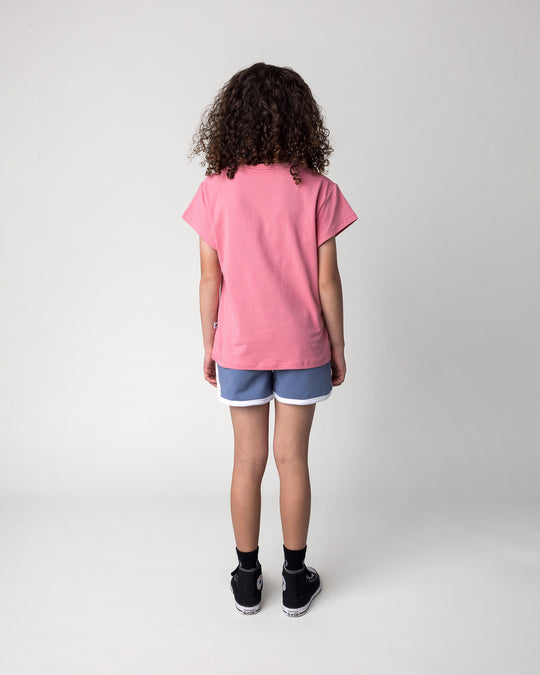 Kid wearing the Sprint Short in cornflower and white with the Cool Crew Tee in candy, back view