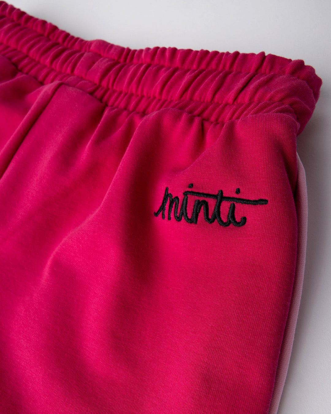 Close up detail of the Sprint Short in crimson and pink