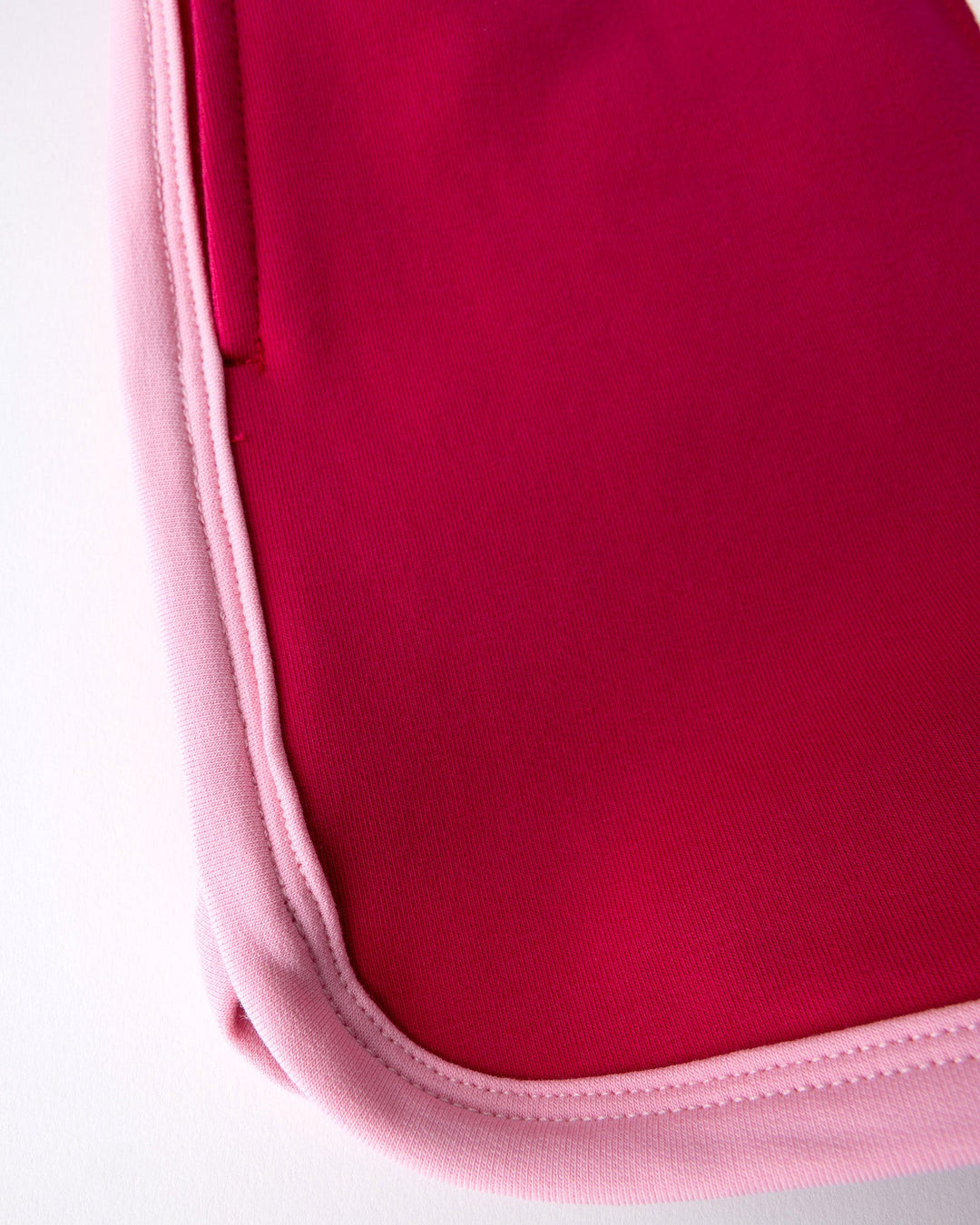 Close up detail of the Sprint Short in crimson and pink
