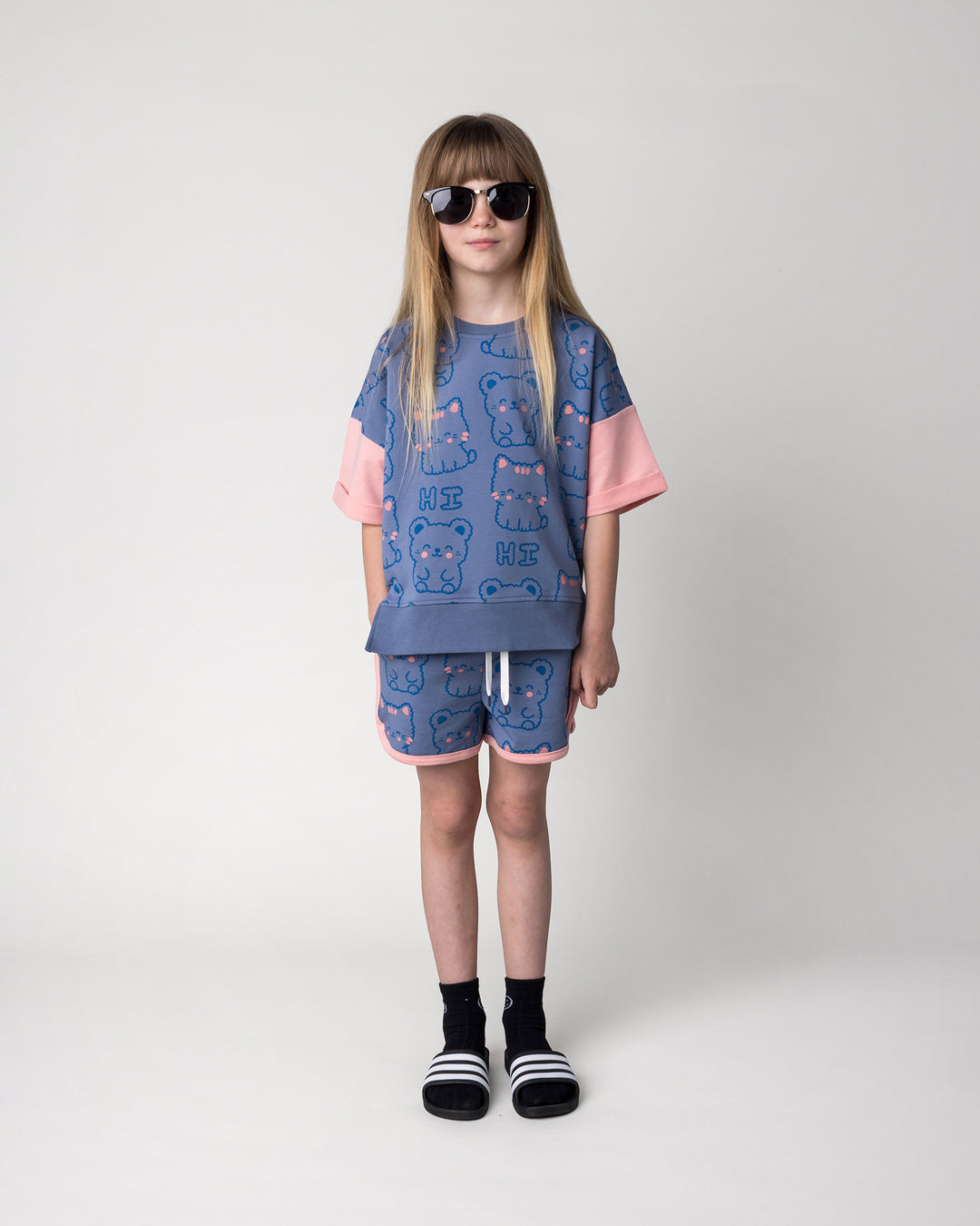Kid wearing the Hi Cat Bear Short in cornflower and pink with the Hi Cat Bear Short Sleeve Crew in cornflower and pink, front view