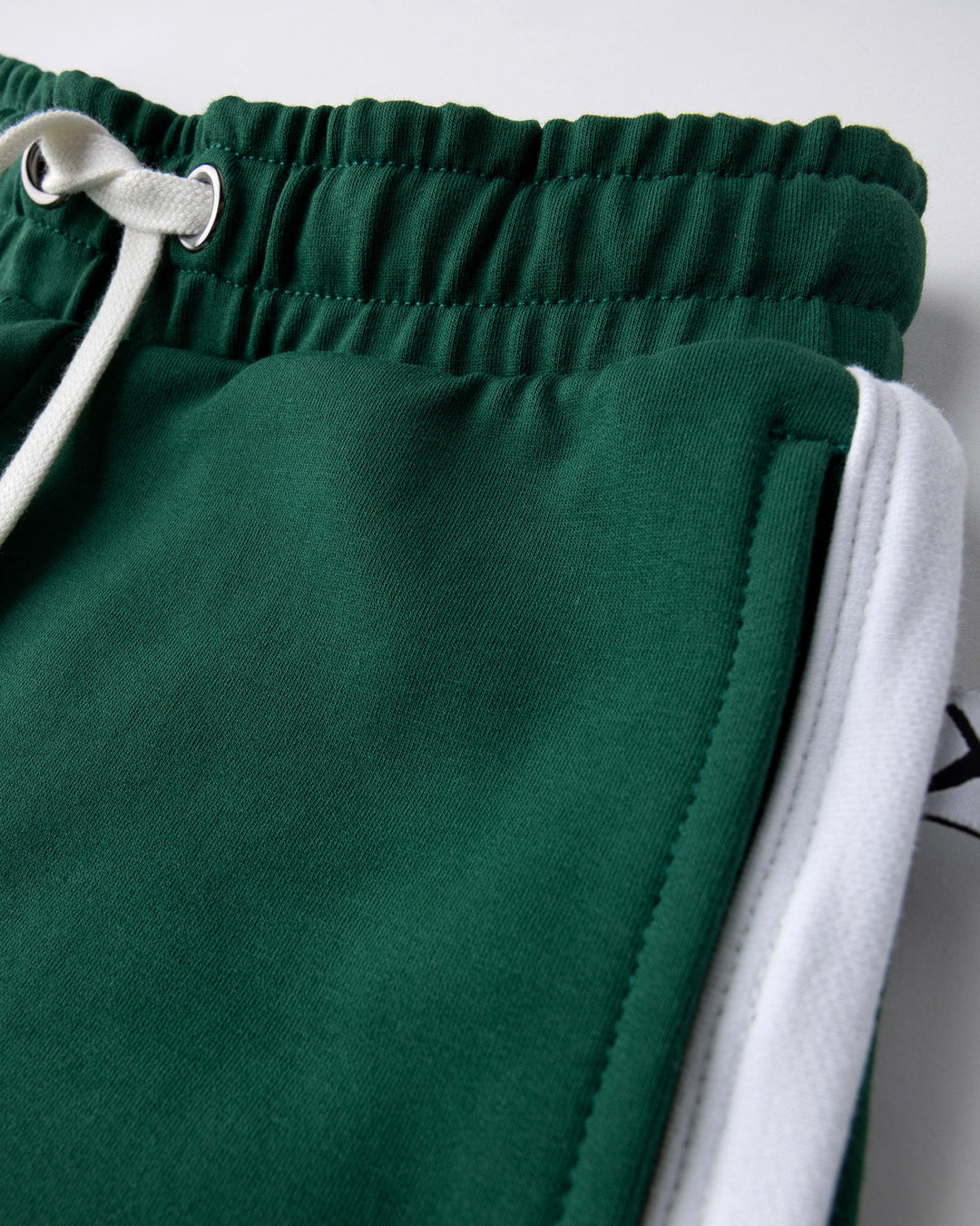 Close up detail of the Sprint Short in kelly green and white