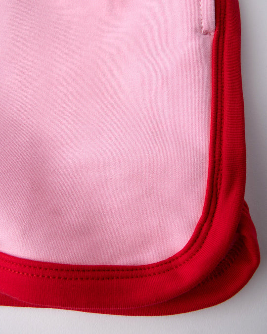 Close up detail of the Sprint Short in pink and red