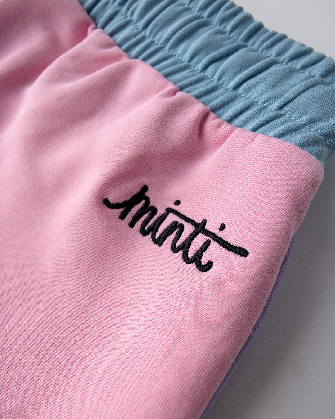 Close up detail of the Sprint Short in pink, purple and aqua