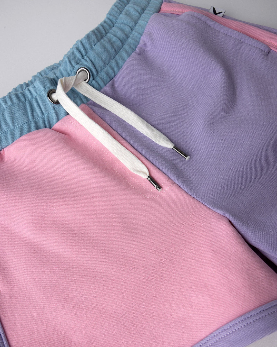 Close up detail of the Sprint Short in pink, purple and aqua