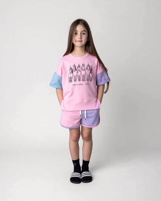 Kid wearing the Sprint Short in pink, purple and aqua with the Unicorn Club Short Sleeve Crew in pink, purple and aqua, front view