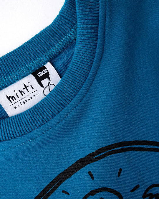 Close up detail of the Chill Sloth Short Sleeve Crew in teal, orange and grey marle